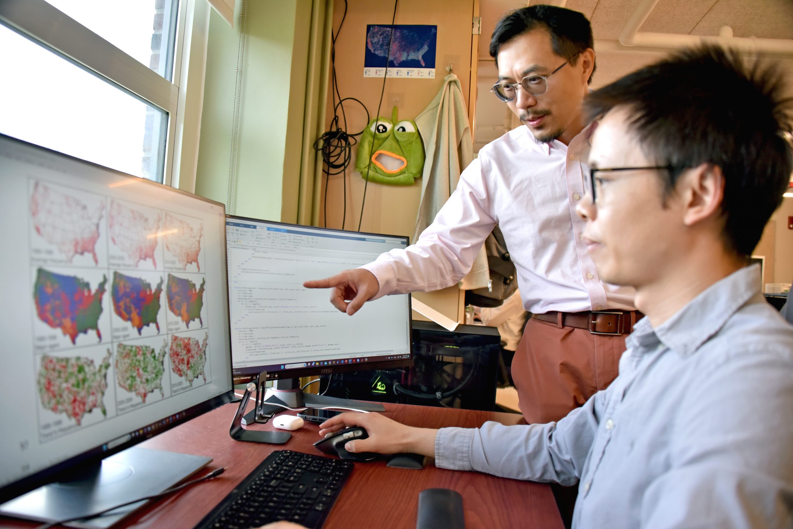 two guys looking at computer 